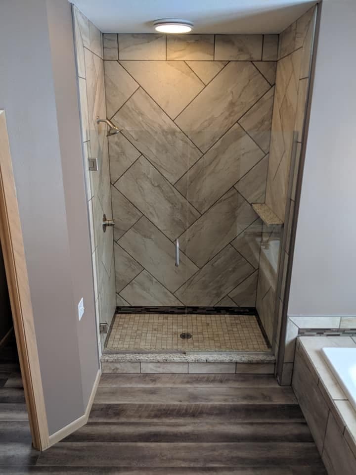 A shower tiled in a herringbone pattern